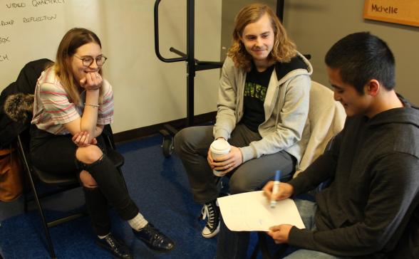 Three people discussing