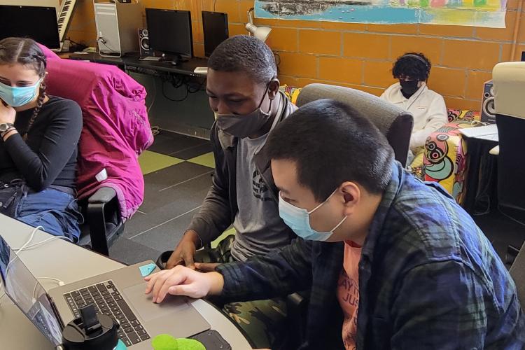 left edge of the image has Estelle sitting in a chair then Moudjib and Theng editing together with Jonathan editing in the background