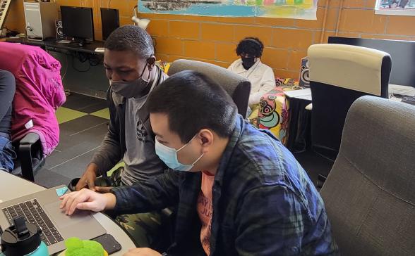 a photo of several students working on computers