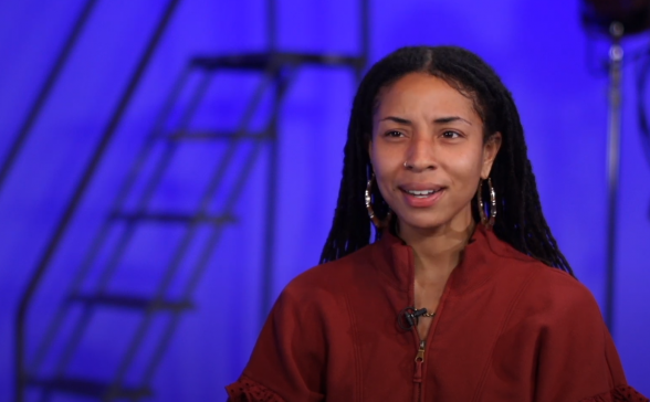 A still from the video. Destiny in front of a blue background