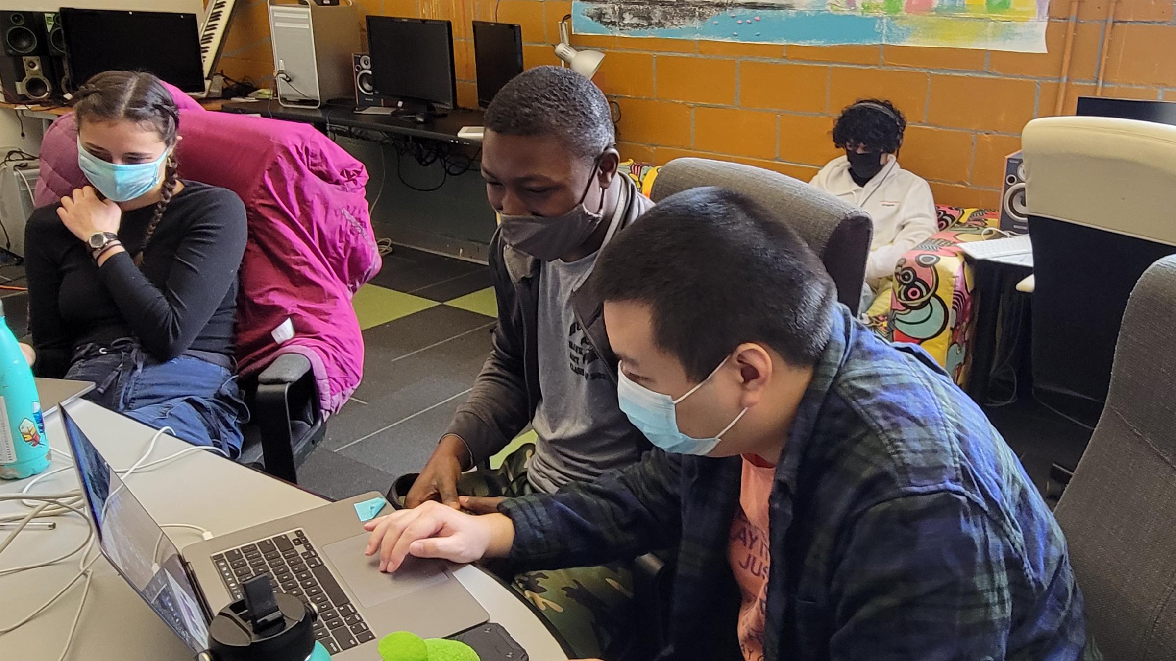 left edge of the image has Estelle sitting in a chair then Moudjib and Theng editing together with Jonathan editing in the background